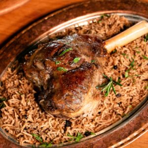Juicy lamb shank served on a bed of aromatic spiced rice.